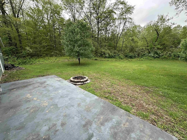 view of yard with an outdoor fire pit and a patio