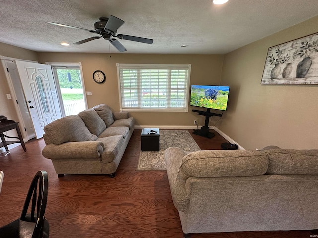 living area featuring a ceiling fan, recessed lighting, a textured ceiling, baseboards, and dark wood-style floors