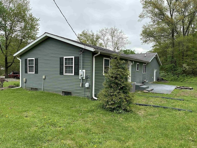 rear view of house featuring a yard, a patio area, and central AC unit