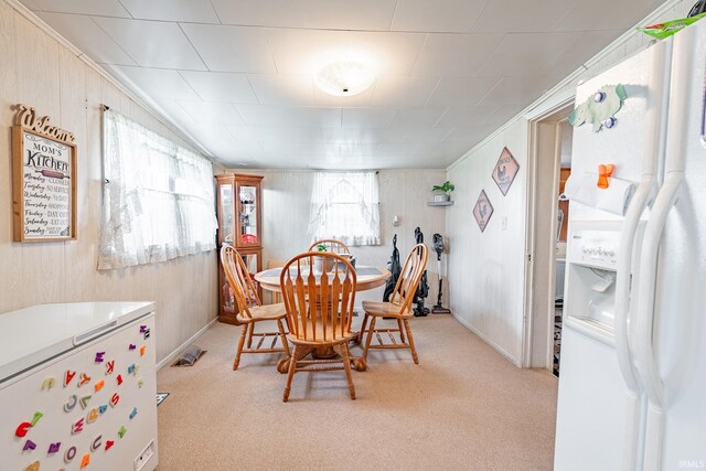 1453 Garfield St, Wabash, IN 46992 - dining space featuring baseboards, wooden walls, ornamental molding, and light colored carpet