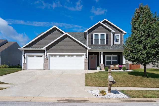 5138 Indigo Ave, Lafayette, IN 47909 - craftsman inspired home featuring covered porch, stone siding, driveway, a garage, and a front yard