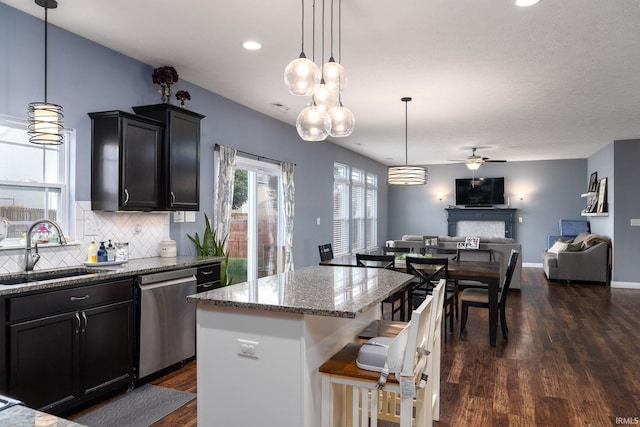 5138 Indigo Ave, Lafayette, IN 47909 - kitchen featuring a sink, dishwasher, open floor plan, a ceiling fan, and light stone countertops
