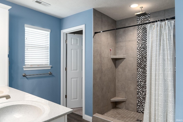 5138 Indigo Ave, Lafayette, IN 47909 - bathroom featuring a sink, double vanity, visible vents, and a tile shower