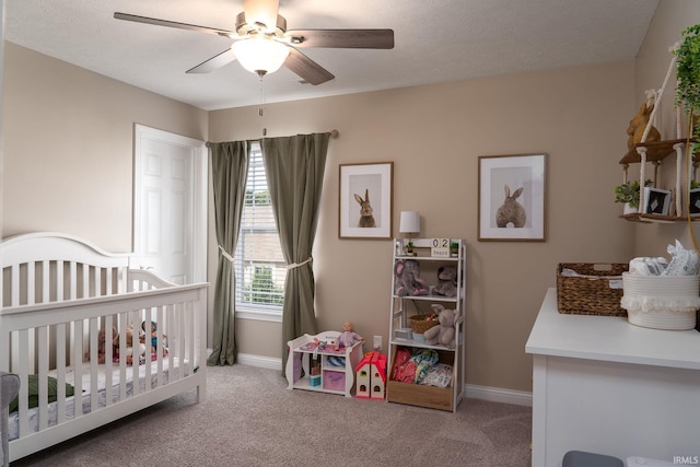 5138 Indigo Ave, Lafayette, IN 47909 - carpeted bedroom with a nursery area, baseboards, and a ceiling fan