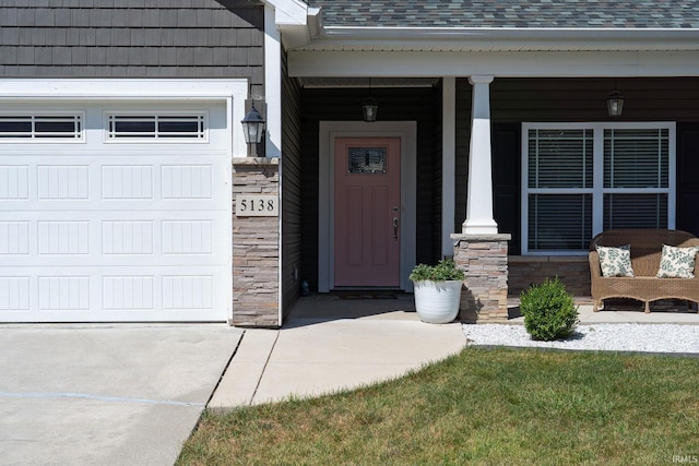 5138 Indigo Ave, Lafayette, IN 47909 - doorway to property with stone siding, covered porch, roof with shingles, and an attached garage