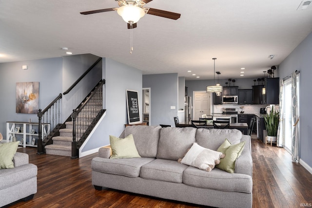 5138 Indigo Ave, Lafayette, IN 47909 - living room featuring a ceiling fan, stairs, visible vents, and dark wood-style floors