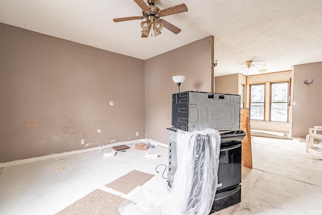 kitchen with concrete flooring and a ceiling fan