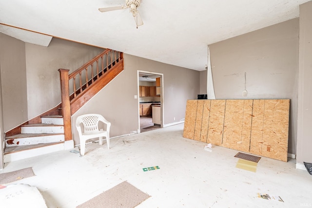 unfurnished living room with stairway, visible vents, and ceiling fan