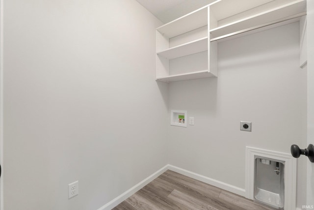 laundry area with laundry area, light wood-type flooring, electric dryer hookup, washer hookup, and baseboards