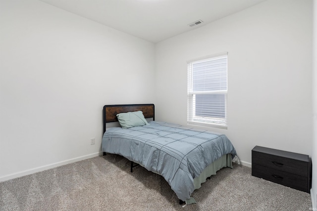 bedroom featuring carpet, visible vents, and baseboards