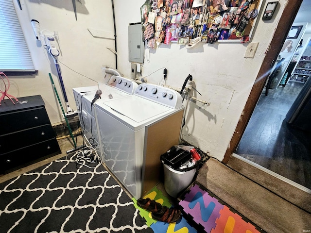 laundry area featuring separate washer and dryer, laundry area, electric panel, and wood finished floors