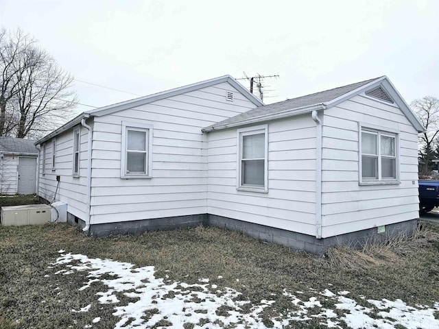 view of side of home featuring crawl space