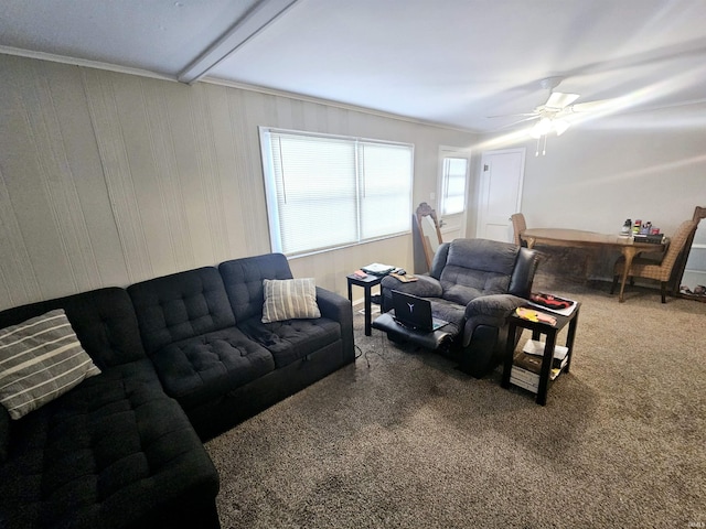 living area with a ceiling fan and carpet