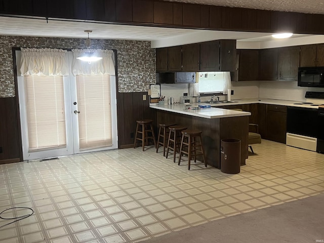 388 Schuetter Rd, Jasper, IN 47546 - kitchen with light floors, black microwave, light countertops, electric range, and wainscoting