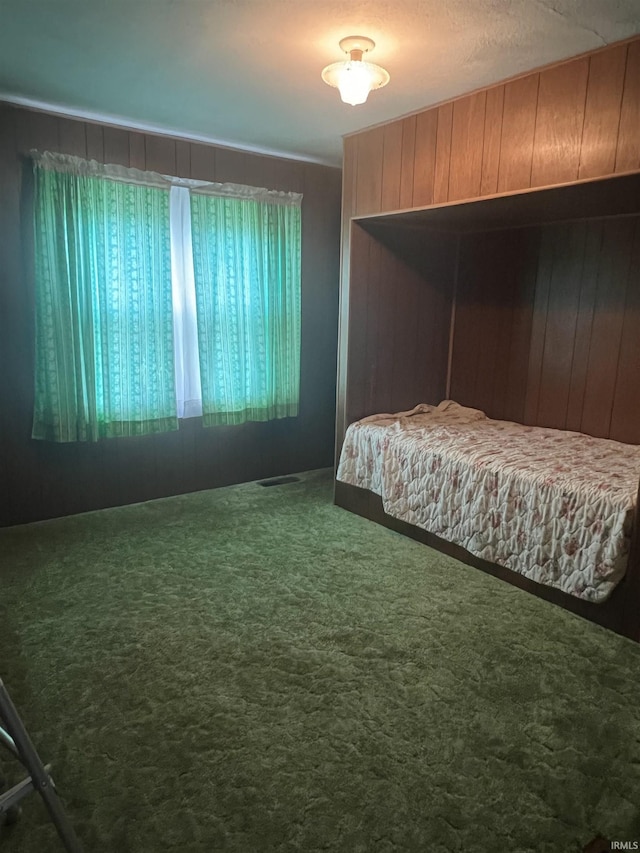 388 Schuetter Rd, Jasper, IN 47546 - bedroom with wood walls, visible vents, and carpet floors