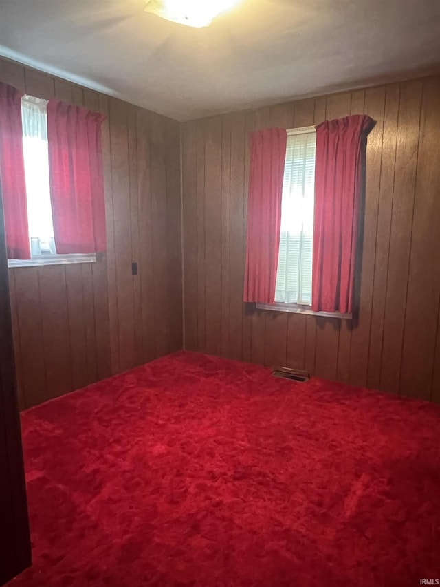 388 Schuetter Rd, Jasper, IN 47546 - spare room featuring wood walls, carpet, and visible vents