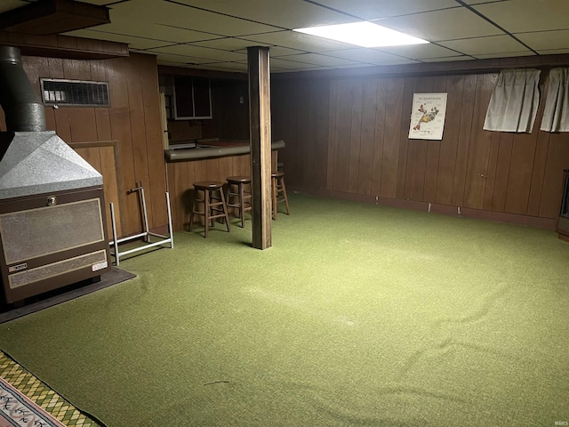 388 Schuetter Rd, Jasper, IN 47546 - finished basement featuring carpet flooring, a wood stove, wood walls, and visible vents