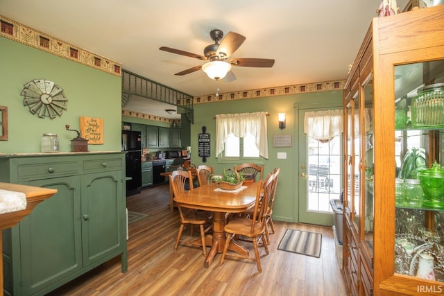 dining space with light wood-type flooring and ceiling fan