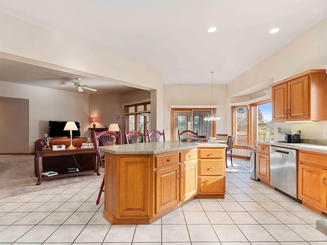 1908 Bent Tree Ct, Auburn, IN 46706 - kitchen featuring dishwasher, a kitchen bar, ceiling fan with notable chandelier, a kitchen island, and light countertops