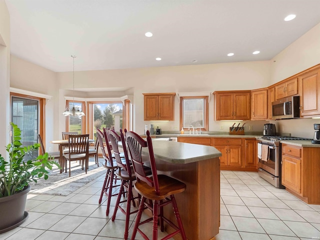 1908 Bent Tree Ct, Auburn, IN 46706 - kitchen with light tile patterned floors, stainless steel appliances, a kitchen bar, and a sink