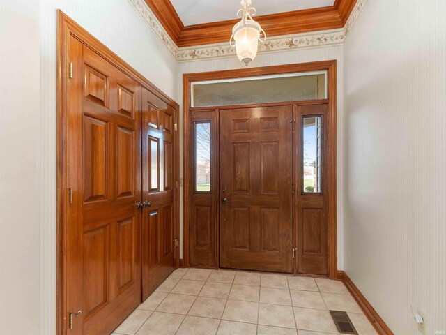 1908 Bent Tree Ct, Auburn, IN 46706 - foyer featuring light tile patterned floors, visible vents, baseboards, and ornamental molding