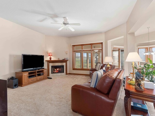 1908 Bent Tree Ct, Auburn, IN 46706 - living room featuring a tile fireplace, light colored carpet, and ceiling fan with notable chandelier