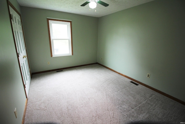 interior space featuring ceiling fan, carpet floors, baseboards, and visible vents