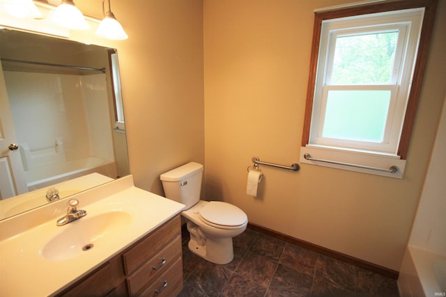 bathroom with baseboards, vanity, toilet, and shower / bathing tub combination