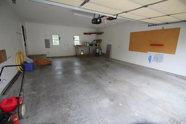 garage featuring electric panel and a garage door opener