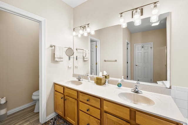 1611 Rockwood Ln, Mishawaka, IN 46545 - full bathroom featuring a sink, double vanity, toilet, and wood finished floors