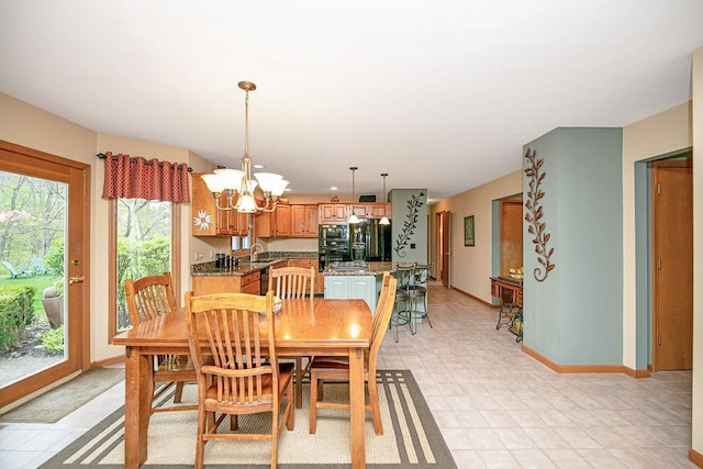 dining space featuring an inviting chandelier and baseboards