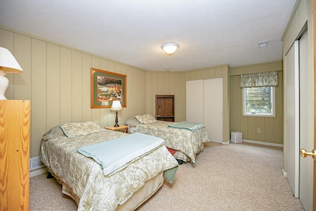 carpeted bedroom featuring a closet, visible vents, and baseboards