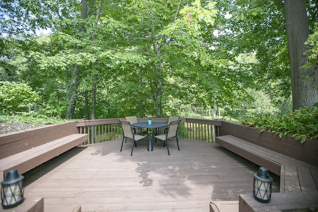 wooden terrace featuring outdoor dining area
