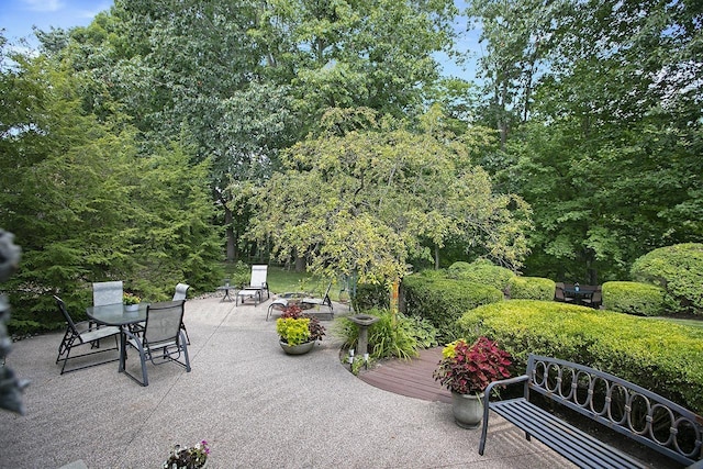 view of home's community featuring a patio area and a wooden deck