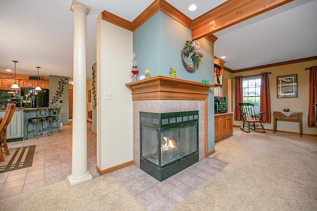 living room with light colored carpet, ornamental molding, baseboards, and ornate columns