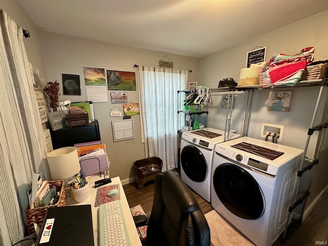 washroom featuring washing machine and dryer, laundry area, and wood finished floors