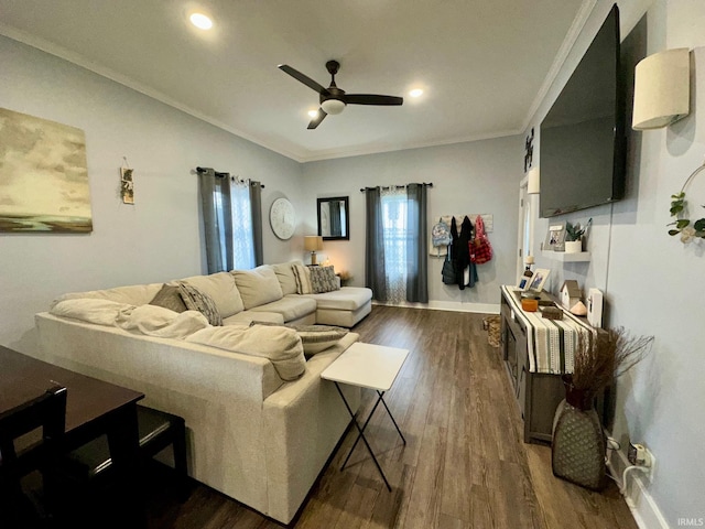 living area with ornamental molding, baseboards, a ceiling fan, and dark wood-type flooring