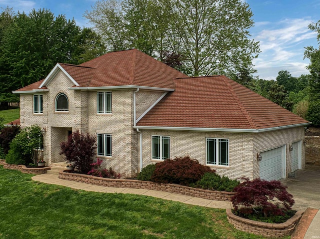 view of front of house featuring concrete driveway, a garage, a front lawn, and brick siding