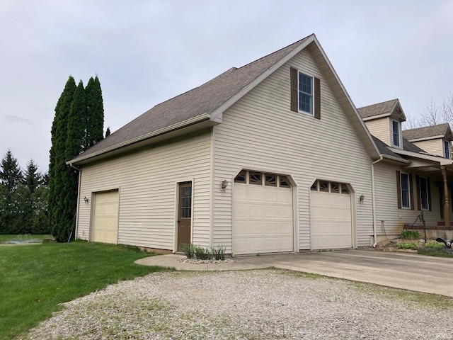 7020 N 20 W, Howe, IN 46746 - view of home's exterior featuring a lawn, driveway, a shingled roof, and an attached garage
