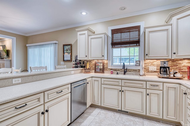 kitchen featuring light countertops, decorative backsplash, stainless steel dishwasher, and a sink