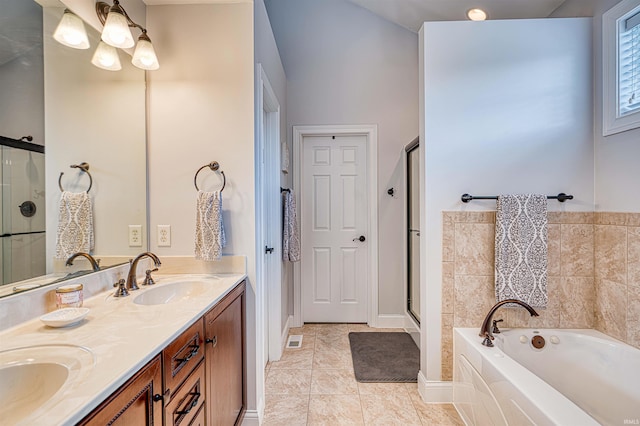 bathroom with visible vents, a sink, a shower stall, a garden tub, and double vanity