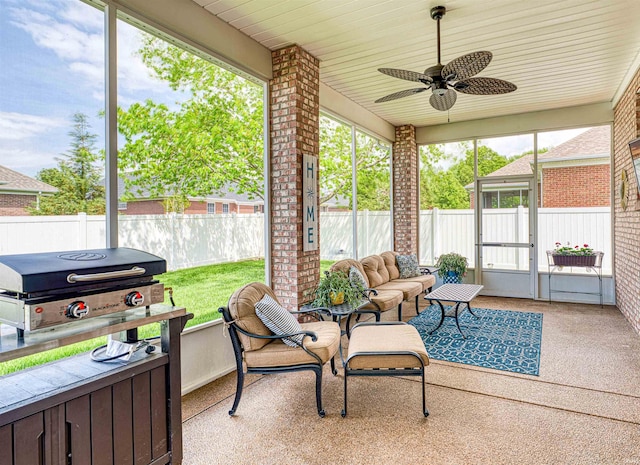 sunroom with outdoor lounge area and a ceiling fan