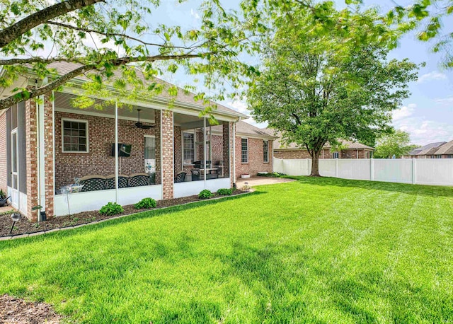 view of yard featuring a sunroom and fence