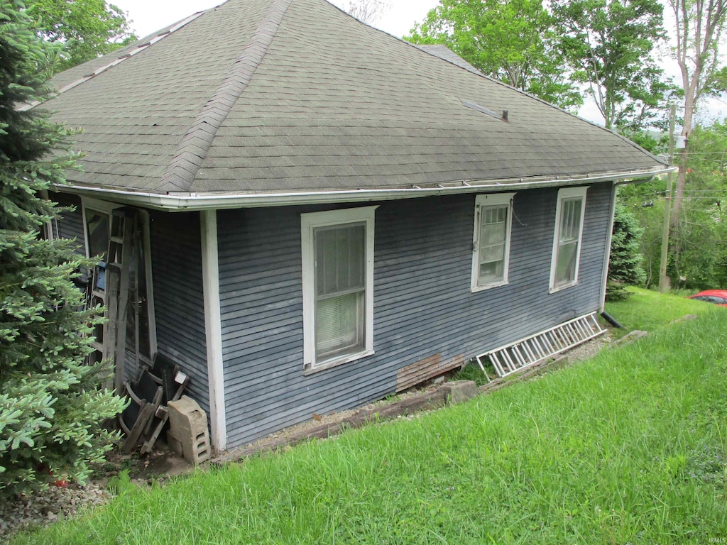 view of home's exterior with a shingled roof