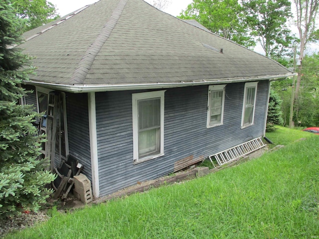 view of home's exterior with a shingled roof