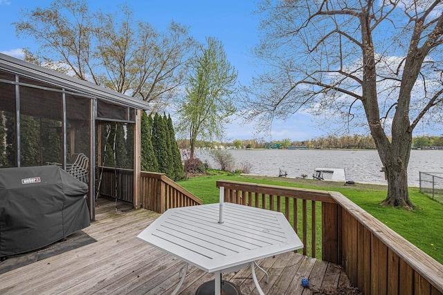 wooden terrace with a yard, grilling area, a sunroom, and a water view