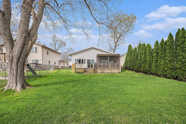 view of yard featuring a sunroom and fence