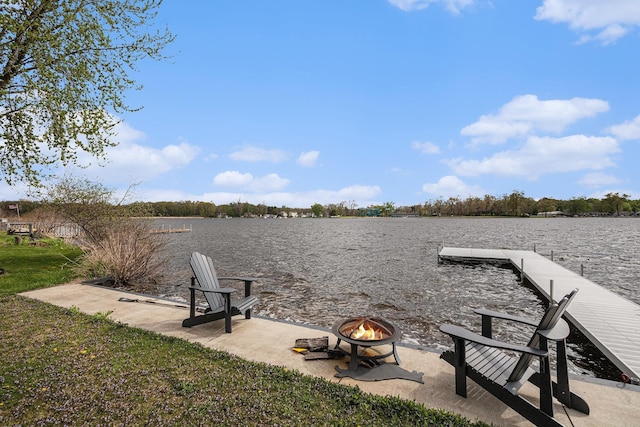 dock area featuring an outdoor fire pit, a water view, and a patio