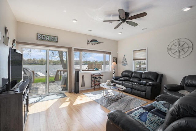 living room with a ceiling fan, light wood-style floors, and recessed lighting