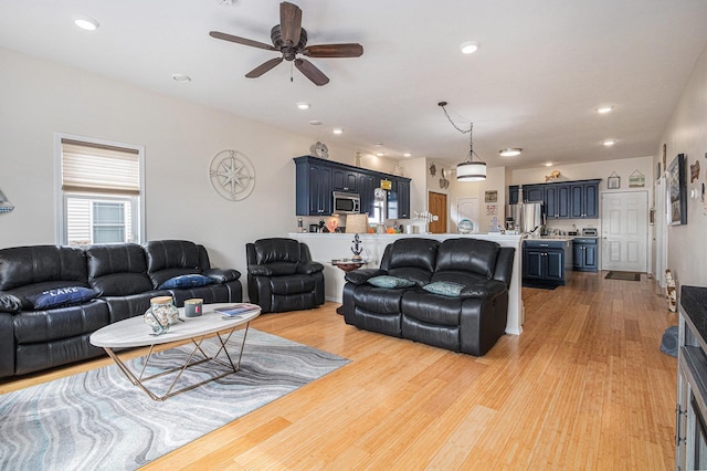 living area featuring recessed lighting, light wood-style floors, and ceiling fan